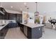 Modern kitchen with dark cabinetry, island, and stainless steel appliances at 18083 W Amber Dr, Goodyear, AZ 85338