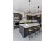 Modern kitchen with dark cabinetry, large island, and stainless steel appliances at 18083 W Amber Dr, Goodyear, AZ 85338