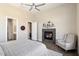 Comfortable main bedroom with a fireplace and access to the bathroom at 16076 E Ridgestone Dr, Fountain Hills, AZ 85268