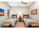 Guest bedroom with two twin beds, nightstands, and southwestern art at 16076 E Ridgestone Dr, Fountain Hills, AZ 85268
