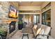 Relax by the fireplace on this covered patio with seating area and TV at 16076 E Ridgestone Dr, Fountain Hills, AZ 85268