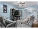 Living room featuring gray sofas, a TV, and light blue walls at 13629 W San Miguel Ave, Litchfield Park, AZ 85340