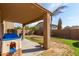 Covered patio, grassy yard, and playset at 16079 W Williams St, Goodyear, AZ 85338