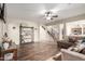 Open living space with hardwood floors, a staircase, and a comfy couch at 16079 W Williams St, Goodyear, AZ 85338