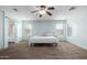 Main bedroom with ensuite bathroom and ceiling fan at 16079 W Williams St, Goodyear, AZ 85338