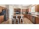 Kitchen with island, stainless steel appliances, and wood cabinets at 16079 W Williams St, Goodyear, AZ 85338