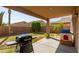 Backyard with covered patio, grill, and playset at 16079 W Williams St, Goodyear, AZ 85338