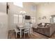 Spacious living room with hardwood floors, a dining area, and a large TV at 16079 W Williams St, Goodyear, AZ 85338