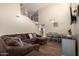 Spacious living room featuring a large sectional sofa and hardwood floors at 16079 W Williams St, Goodyear, AZ 85338