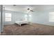 Spacious main bedroom with carpeted floors and lots of natural light at 16079 W Williams St, Goodyear, AZ 85338