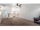 Spacious loft area with carpeted floors and ceiling fan at 16079 W Williams St, Goodyear, AZ 85338