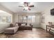 Bright living room with a comfortable sectional sofa and wood-look tile floors at 16079 W Williams St, Goodyear, AZ 85338