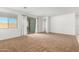 Living room with carpet, sliding glass doors, and neutral-colored walls at 14436 W Faye Way, Surprise, AZ 85387