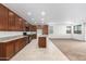 Open kitchen with granite countertops and dark wood cabinets at 14436 W Faye Way, Surprise, AZ 85387