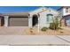 Modern stucco home with a two-car garage and desert landscaping at 14436 W Faye Way, Surprise, AZ 85387