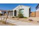 Modern house exterior with a landscaped yard and a wooden gate at 14436 W Faye Way, Surprise, AZ 85387