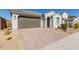 House exterior featuring a two-car garage and a well-manicured front yard at 14436 W Faye Way, Surprise, AZ 85387