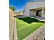 Artificial turf backyard with covered patio and gravel border at 14436 W Faye Way, Surprise, AZ 85387