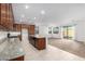Open kitchen with granite counters, dark wood cabinets and an island at 14436 W Faye Way, Surprise, AZ 85387