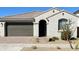 Modern stucco home with a two-car garage and desert landscaping at 14436 W Faye Way, Surprise, AZ 85387