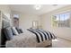 Bright bedroom with a striped comforter and large window at 4517 W Lodge Dr, Laveen, AZ 85339