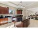 Spacious kitchen featuring an island, dark wood cabinets, and granite countertops at 4517 W Lodge Dr, Laveen, AZ 85339
