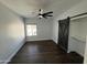 Bright bedroom with dark floors and barn door leading to closet at 14000 N 94Th St # 1037, Scottsdale, AZ 85260