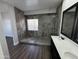 Modern bathroom with double vanity, large shower, and dark wood-look flooring at 14000 N 94Th St # 1037, Scottsdale, AZ 85260