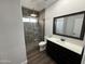 Bathroom with walk-in shower, toilet, and dark vanity at 14000 N 94Th St # 1037, Scottsdale, AZ 85260