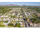 Aerial view of neighborhood with various homes and landscape with mountains in the distance at 930 W Maryland Ave, Phoenix, AZ 85013