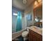 Charming bathroom with teal shower curtain, wood vanity, and a mirror at 650 N Hawes Rd # 3820, Mesa, AZ 85207