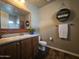 Bathroom with wood vanity, large mirror, and a toilet at 650 N Hawes Rd # 3820, Mesa, AZ 85207