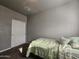 Simple bedroom with a twin bed, double door closet and neutral colored walls at 650 N Hawes Rd # 3820, Mesa, AZ 85207