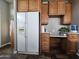 Kitchen boasts built-in desk, wood cabinets, and a large refrigerator at 650 N Hawes Rd # 3820, Mesa, AZ 85207