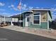 Tan and green manufactured home exterior at 650 N Hawes Rd # 3820, Mesa, AZ 85207