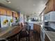Open kitchen features wood cabinets, island with seating, and stainless steel appliances at 650 N Hawes Rd # 3820, Mesa, AZ 85207
