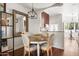 Charming dining area with a rustic table and a view into the kitchen at 4955 E Indian School Rd # 9, Phoenix, AZ 85018