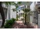 Inviting entryway with a cobblestone path and lush landscaping at 4955 E Indian School Rd # 9, Phoenix, AZ 85018