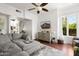 Open living room with grey sectional sofa and hardwood floors at 4955 E Indian School Rd # 9, Phoenix, AZ 85018