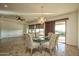 Bright dining room features a glass table, six chairs, and sliding glass doors leading to a patio at 20447 N 266Th Ave, Buckeye, AZ 85396