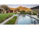 Luxury pool with spa and mountain views, surrounded by lush landscaping at 10493 E Rimrock Dr, Scottsdale, AZ 85255
