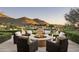 Firepit surrounded by wicker chairs on a patio with mountain views at 10493 E Rimrock Dr, Scottsdale, AZ 85255