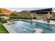 Inviting pool area with pergola and seating, offering scenic mountain views at 10493 E Rimrock Dr, Scottsdale, AZ 85255