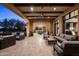 Evening view of a covered patio with seating and mountain views at 10493 E Rimrock Dr, Scottsdale, AZ 85255