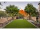 Landscaped backyard with mountain views and artificial turf at 10493 E Rimrock Dr, Scottsdale, AZ 85255