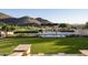Resort-style pool and spa with pergola, fire pit, and mountain views at 10493 E Rimrock Dr, Scottsdale, AZ 85255
