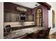 Custom wet bar with wine storage and granite countertop at 10493 E Rimrock Dr, Scottsdale, AZ 85255