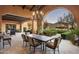 Outdoor dining area on a covered patio with mountain views at 10493 E Rimrock Dr, Scottsdale, AZ 85255