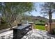 Outdoor kitchen with built-in grill, granite countertop, and mountain views at 10493 E Rimrock Dr, Scottsdale, AZ 85255