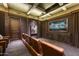 Home theater with large screen TV and comfortable leather seating at 10493 E Rimrock Dr, Scottsdale, AZ 85255